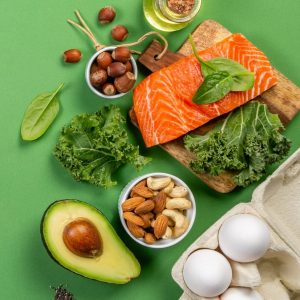 Keto diet concept - salmon, avocado, eggs, nuts and seeds